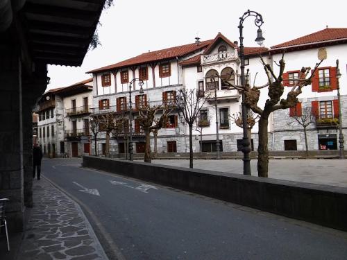 an empty city street with a white building at Hostal Ekaitza in Lesaka