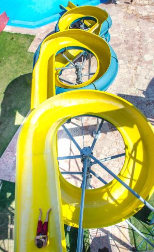 a row of yellow slides on a playground at Gran Texier Hotel Casino in Concepción del Uruguay