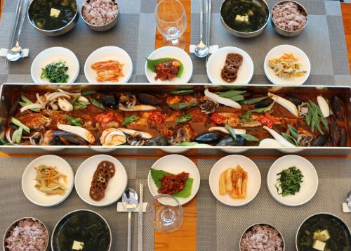 a table with plates of food and bowls of food at Utop Ubless Hotel Jeju in Jeju