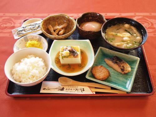 a tray of food with rice and bowls of food at Hotel Innoshima in Onomichi