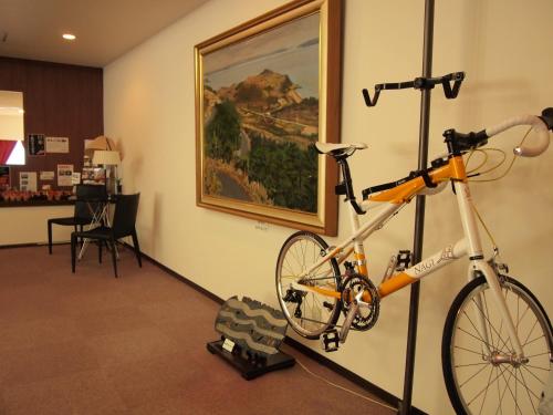 a bike is hanging on a wall in a room at Hotel Innoshima in Onomichi