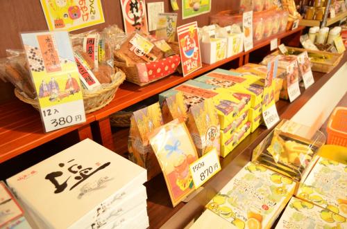 a store shelf with many different types of packaged food at Hotel Innoshima in Onomichi