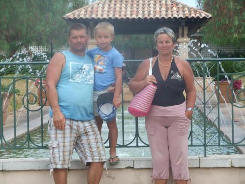 a man and a woman standing next to a child at Gîte Les Grands Champs in Bellentre