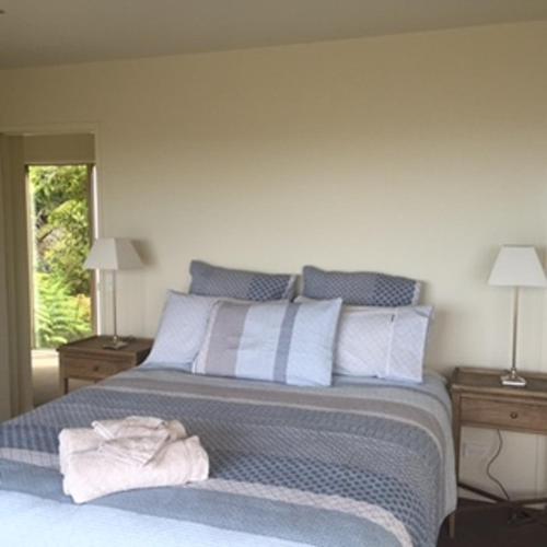 a bedroom with a bed with a towel on it at Hahei Sea Vista (2) in Hahei