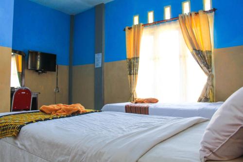 Säng eller sängar i ett rum på Hotel Edelweis 2 Bajawa