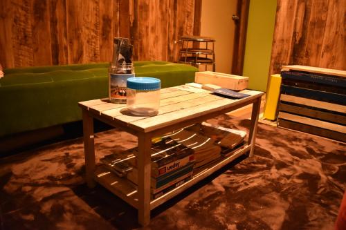 a wooden coffee table in a living room with a green couch at Villa Sacra in Kamakura
