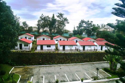 a row of white houses with red roofs at Forest Crest Nature Hotel and Resort Powered by ASTON in Nasugbu