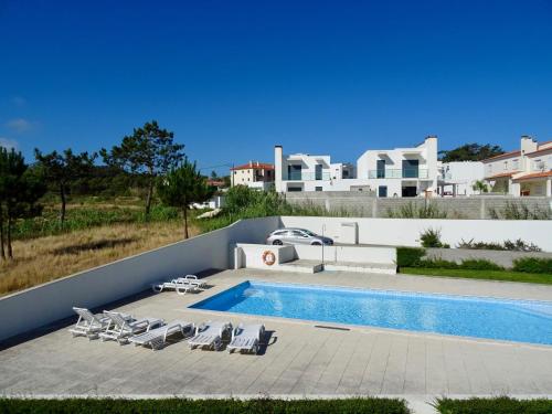 a villa with a swimming pool and a house at Bela Baïa in Salir de Porto