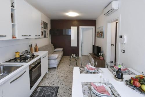a kitchen and living room with a sink and a table at Brick House Treviso in Treviso