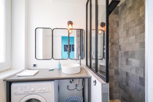 une salle de bain avec un lavabo et une machine à laver dans l'établissement Le Boz'art, à Montpellier