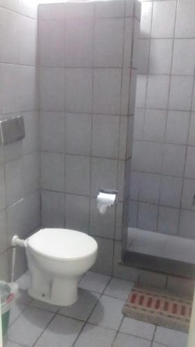 a bathroom with a toilet and a shower at Casa Praia do Forte in Cabo Frio