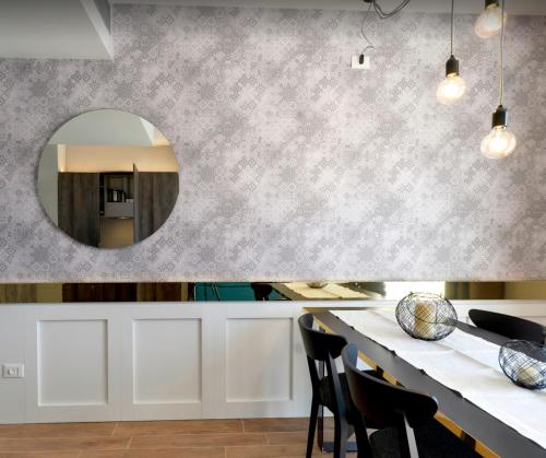 a kitchen with a mirror and a table with chairs at Residence Ten Suite in Rimini