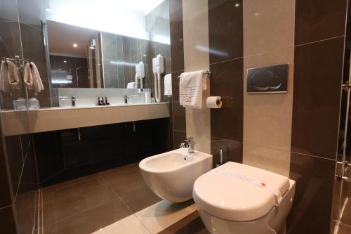 a bathroom with a toilet and a sink at Hotel Zenica in Zenica