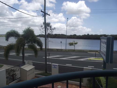 a view of a street with a river and a road at River Sands Apartments in Maroochydore