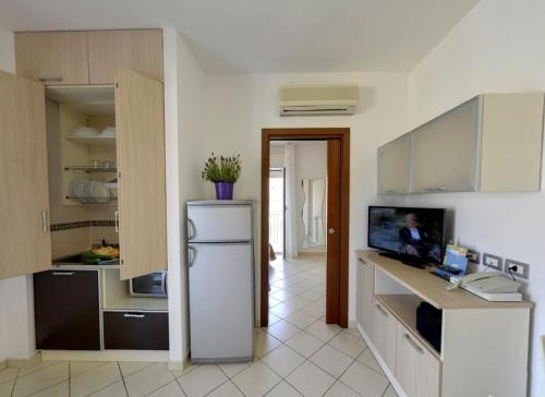 a kitchen with a refrigerator in the middle of it at Residence Mareo in Riccione