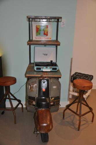 a tv sitting on a motorcycle with two chairs at Hotel Rauw aan de Kade in IJmuiden