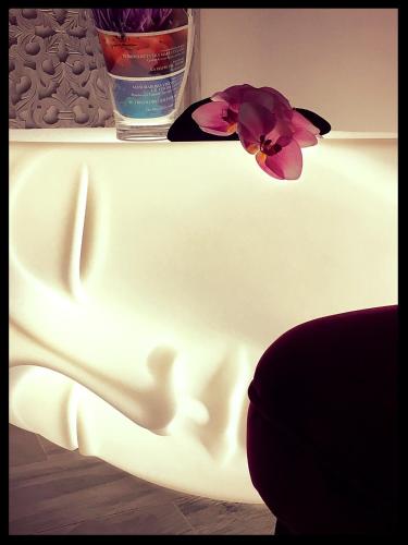 a pink flower sitting on top of a white table at Casa Busari in Palermo