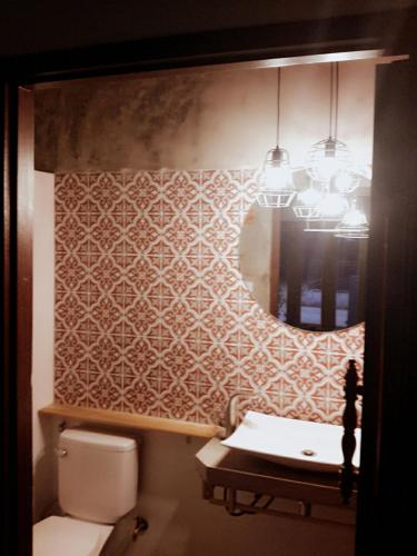 a bathroom with a toilet and a sink and a mirror at Moonlight Champa Riverview in Luang Prabang