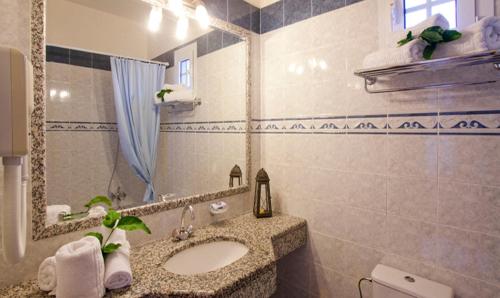 a bathroom with a sink and a mirror at Pefkos Filoxenia in Pefki Rhodes