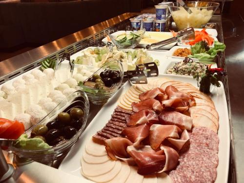 a buffet with many different types of food on a table at Premium Wellness Institute in Bucharest