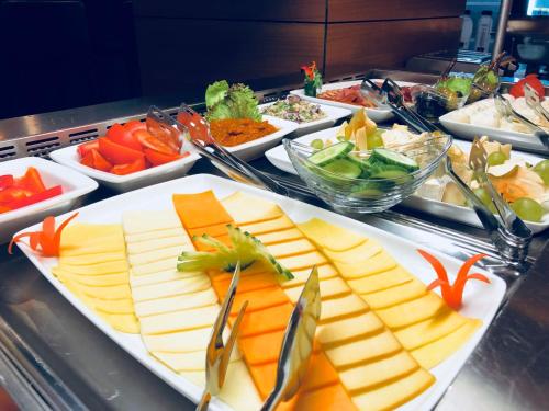 a buffet with several plates of cheese and vegetables at Premium Wellness Institute in Bucharest