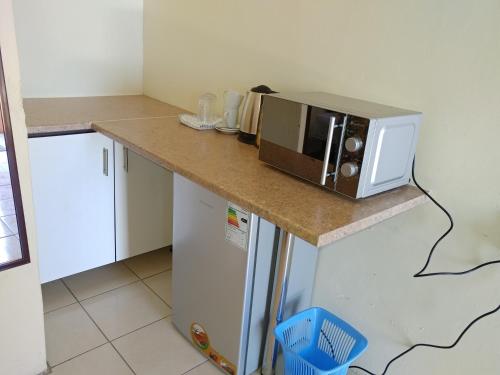 a microwave sitting on top of a counter in a kitchen at Hillside View Guesthouse in Coffee Bay