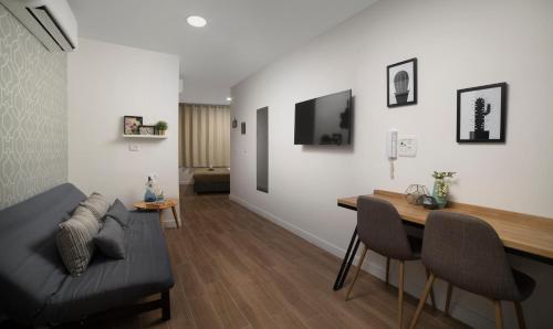 a living room with a couch and a table at Diana Hotel in Haifa