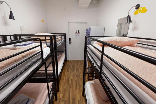 a room with three bunk beds in a hospital at CheapSleep Hostel Helsinki in Helsinki