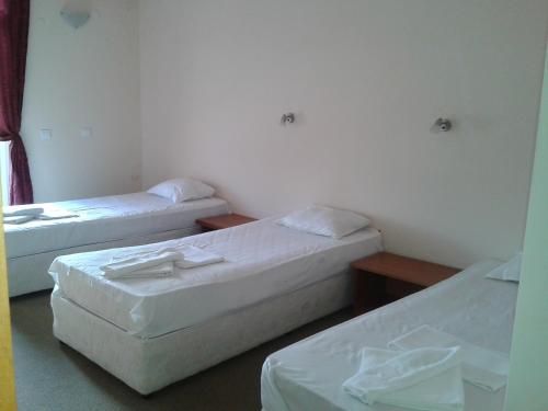 a room with two beds and two tables at Hotel Seasons 2 in Sunny Beach