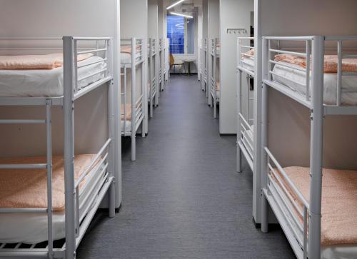 a row of bunk beds in a dorm room at CheapSleep Hostel Helsinki in Helsinki