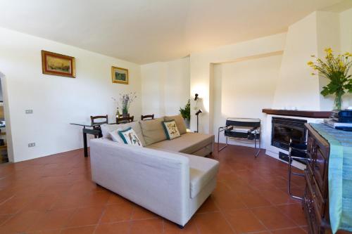 a living room with a white couch and a fireplace at Tuscan Sun Villa in Florence
