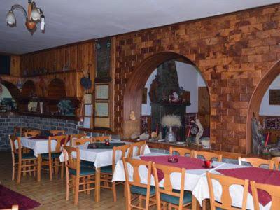 un restaurante con mesas y sillas y una pared de ladrillo en Natasa Rooms en Filippaioi