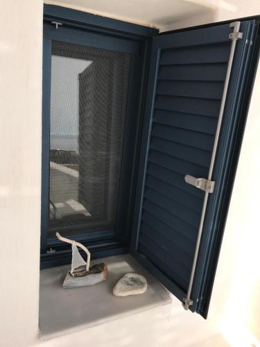 a pair of shoes sitting next to a window at Vegera Beach House, Donoussa in Donoussa