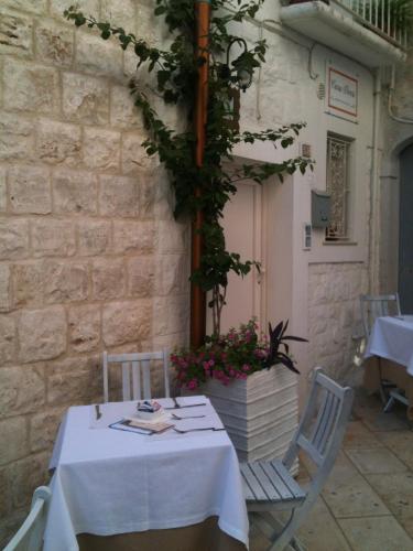 a table and chairs in front of a building at B&B Casa Dorsi in Polignano a Mare
