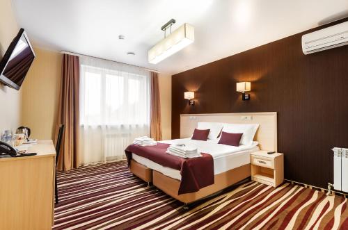 Кровать или кровати в номере Отель Дегас Лайт