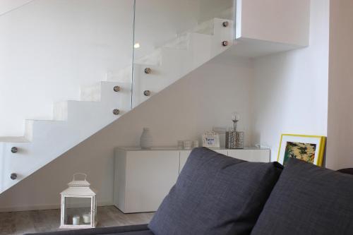 a living room with a couch and a staircase at Country House Tagliaferro in Marciana Marina