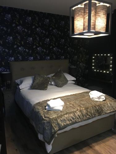 a bedroom with a bed with towels on it at The Torfin in Edinburgh