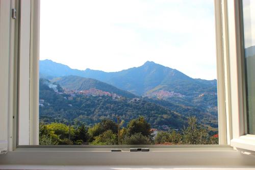 a window with a view of a mountain view at Country House Tagliaferro in Marciana Marina