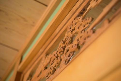 a wooden door with a design on the side of it at Guest House DOUGO-YADO in Matsuyama