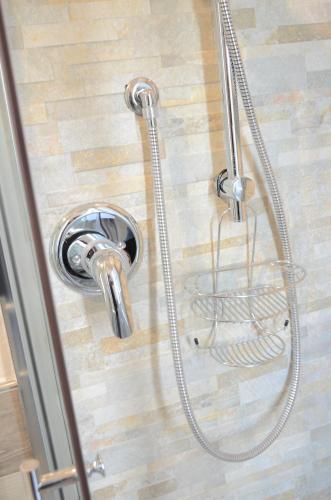 a shower with a shower head in a bathroom at Casa Aurora B&B in Chieti