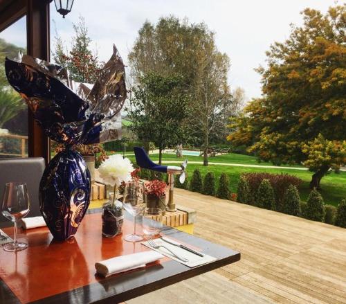 a wooden table with a vase on top of it at Boma Countryhouse in Casale Bufalotta