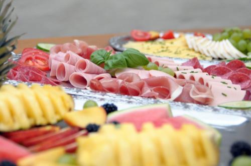a table topped with lots of different types of food at City Hotel-Pension Brandenburg in Brandenburg an der Havel