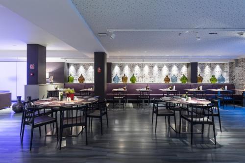 a restaurant with tables and chairs in a room at Catalonia Square 4* Sup in Barcelona