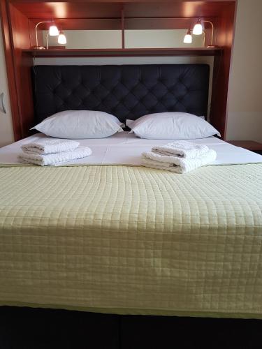 a bed with two towels on top of it at Villa Jelena in Zadar