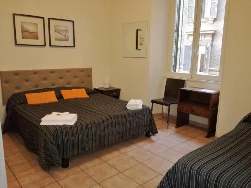 a bedroom with a bed and a chair and a window at Marvi Hotel in Rome