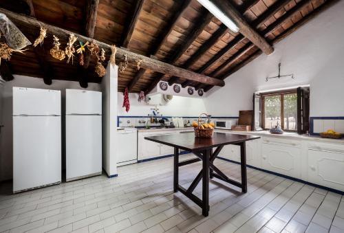 a kitchen with white appliances and a wooden ceiling at Monte do Serrado De Baixo in Évora