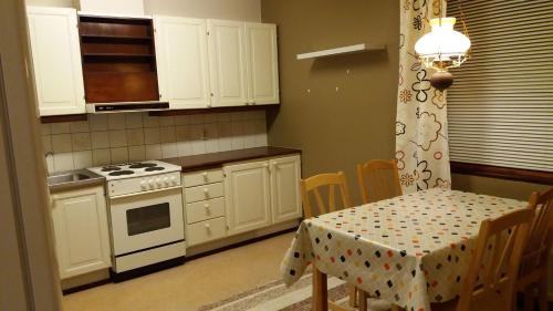 a kitchen with a table and a stove top oven at Nice spacious home in Vaasa