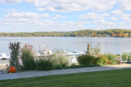 a boat on a lake with trees in the background at Bay Pointe Inn in Orangeville