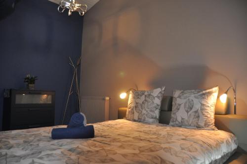 a bedroom with a bed with a blue toy on it at Chambre d'hôtes Sauternais in Pujols-sur-Ciron