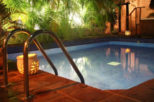 a swimming pool with a stairway leading to a swimming pool at La Pasion Colonial Hotel Boutique By Bunik in Playa del Carmen